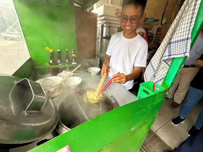 Man cooking noodles